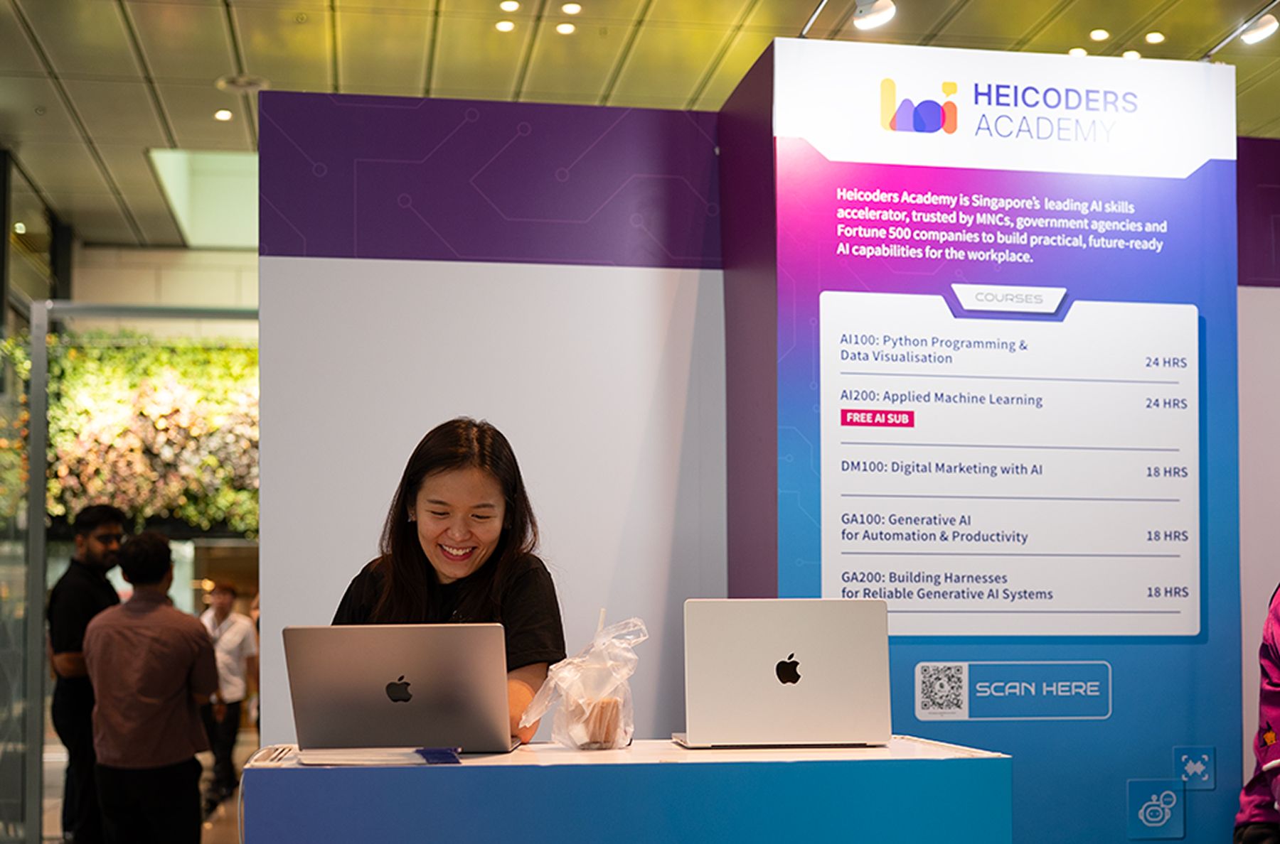 Heicoders facilitators guiding participants through the AI booths